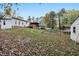 Sprawling backyard with mature trees, a deck, a greenhouse, and storage shed at 928 Magnolia Ridge Way, Fuquay Varina, NC 27526