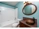 Updated bathroom with tub, shower, and copper vessel sink on a wooden vanity at 928 Magnolia Ridge Way, Fuquay Varina, NC 27526