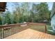View from the wood deck overlooking the lush backyard and mature trees at 928 Magnolia Ridge Way, Fuquay Varina, NC 27526