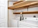 Practical laundry room with storage shelves, washer, and dryer at 928 Magnolia Ridge Way, Fuquay Varina, NC 27526