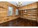 Cozy room with all wood plank interior, shelving, and hardwood floors at 928 Magnolia Ridge Way, Fuquay Varina, NC 27526