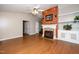 Cozy living room with a decorative fireplace and hardwood flooring at 928 Magnolia Ridge Way, Fuquay Varina, NC 27526