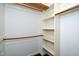 This walk-in closet features white walls, dark wood floor, and several shelves and rods for clothes at 928 Magnolia Ridge Way, Fuquay Varina, NC 27526