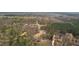 Aerial view of new construction home and surrounding area, including a winding road and wooded lots at 0 Jasmine Rd, Fuquay Varina, NC 27526