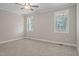 Bright bedroom with two windows, neutral walls, carpet, and ceiling fan at 0 Jasmine Rd, Fuquay Varina, NC 27526