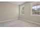 Bright bedroom with neutral paint, carpet, two windows letting in natural light, and baseboard trim at 0 Jasmine Rd, Fuquay Varina, NC 27526