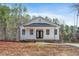 New construction home with a brick foundation, vinyl siding, covered porch and double-door entrance at 0 Jasmine Rd, Fuquay Varina, NC 27526