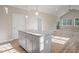 Kitchen island features granite countertop with pendant lights and a view into the living room at 0 Jasmine Rd, Fuquay Varina, NC 27526
