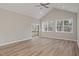 Living room with hardwood floors, ceiling fan, and sliding glass doors opening to a patio at 0 Jasmine Rd, Fuquay Varina, NC 27526