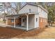 Rear view of brick and vinyl home with a covered back porch at 100 Royall Rd, Oxford, NC 27565