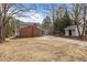 Spacious backyard featuring an outbuilding and a brick exterior with a cozy porch at 100 Royall Rd, Oxford, NC 27565