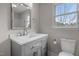 Updated bathroom with a modern vanity, toilet and new mirror, offering a clean aesthetic at 100 Royall Rd, Oxford, NC 27565