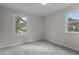 Bright bedroom with two windows and neutral carpet for a fresh, modern look at 100 Royall Rd, Oxford, NC 27565