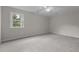 Bright carpeted bedroom with ceiling fan and large window offering plenty of natural light at 100 Royall Rd, Oxford, NC 27565
