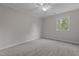 Comfortable carpeted bedroom with ceiling fan, complemented by natural light from the window at 100 Royall Rd, Oxford, NC 27565