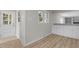 Hallway with white trim, hardwood flooring, and natural light at 100 Royall Rd, Oxford, NC 27565