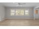 Living room featuring large windows, light colored walls, and wood flooring at 100 Royall Rd, Oxford, NC 27565