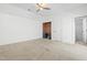 Bright bedroom featuring neutral carpet, built-in desk area, and access to an ensuite bathroom at 10210 Sablewood Drive # 112, Raleigh, NC 27617