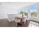 Dining room with a wooden table, seating for six, and natural light from the windows at 10210 Sablewood Drive # 112, Raleigh, NC 27617
