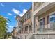 Charming townhome showcases a brick facade, private balconies, and inviting curb appeal with a blue sky at 10210 Sablewood Drive # 112, Raleigh, NC 27617