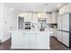 Modern kitchen features a large island, stainless steel appliances, and beautiful tile backsplash at 10210 Sablewood Drive # 112, Raleigh, NC 27617