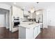 Bright kitchen featuring white cabinets, stainless steel appliances, backsplash, and island with pendant lighting at 10210 Sablewood Drive # 112, Raleigh, NC 27617