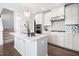 Well-equipped kitchen boasts stainless appliances, a stylish backsplash, and a spacious center island at 10210 Sablewood Drive # 112, Raleigh, NC 27617
