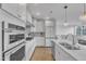 Bright kitchen with white cabinets, stainless steel appliances, and modern pendant lighting at 10210 Sablewood Drive # 112, Raleigh, NC 27617