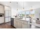 Modern kitchen with quartz countertops, an island with a sink, and stainless appliances at 10210 Sablewood Drive # 112, Raleigh, NC 27617