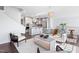 Open-concept living room and kitchen with hardwood floors, modern furniture, and stainless steel appliances at 10210 Sablewood Drive # 112, Raleigh, NC 27617