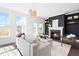Bright living room with fireplace, white sofa, modern lighting fixture, and plenty of natural light at 10210 Sablewood Drive # 112, Raleigh, NC 27617