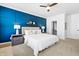 This primary bedroom is bright, with a blue accent wall and walk-in closet at 10210 Sablewood Drive # 112, Raleigh, NC 27617
