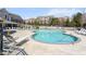 Resort-style community pool with ample seating for residents to relax and enjoy the outdoors on a sunny day at 10210 Sablewood Drive # 112, Raleigh, NC 27617