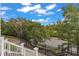 From the top of townhouse steps: View of a sidewalk, manicured foliage, and a street lined with mature trees at 10210 Sablewood Drive # 112, Raleigh, NC 27617