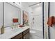 Bright bathroom features white countertops, dark wood cabinets, and a shower-tub combo at 1028 Zelkova Ln, Chapel Hill, NC 27517