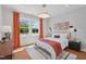Well-lit bedroom with light gray walls, bright windows, a patterned rug, and orange drapes at 1028 Zelkova Ln, Chapel Hill, NC 27517