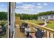 Outdoor deck featuring seating, views of the community lawn and wooded area at 1028 Zelkova Ln, Chapel Hill, NC 27517