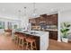 Stylish kitchen with a large center island, pendant lighting, stainless steel appliances, and wood floors at 1028 Zelkova Ln, Chapel Hill, NC 27517