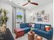 Inviting living room features a plush blue sectional sofa, round wood tables, and stylish wall art at 1028 Zelkova Ln, Chapel Hill, NC 27517