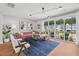 Inviting living room featuring a plush sofa, modern decor, and a sliding glass door to a deck at 1028 Zelkova Ln, Chapel Hill, NC 27517
