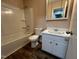 Bathroom with a combined tub and shower, white vanity, and wood-look flooring at 103 Beam Cir, Louisburg, NC 27549