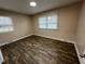 Bedroom with two windows providing natural light and wood-look flooring at 103 Beam Cir, Louisburg, NC 27549
