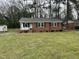 Traditional home with a well-maintained lawn at 103 Beam Cir, Louisburg, NC 27549