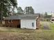 Charming brick ranch exterior with white siding and mature trees at 103 Beam Cir, Louisburg, NC 27549