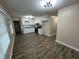 Spacious open-concept kitchen featuring white cabinets, stainless steel appliances, and hardwood floors at 103 Beam Cir, Louisburg, NC 27549
