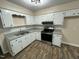 Bright kitchen featuring modern appliances and white cabinets at 103 Beam Cir, Louisburg, NC 27549