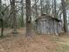Rustic wood outbuilding surrounded by mature trees at 103 Beam Cir, Louisburg, NC 27549