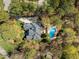 Aerial view of a private home with a pool surrounded by mature trees at 10540 Byrum Woods Dr, Raleigh, NC 27613