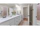 Bright bathroom featuring double sinks, tile floor and a separate shower/tub at 10540 Byrum Woods Dr, Raleigh, NC 27613