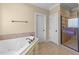 A soaking tub and walk in shower create a relaxing retreat in this bathroom at 10540 Byrum Woods Dr, Raleigh, NC 27613